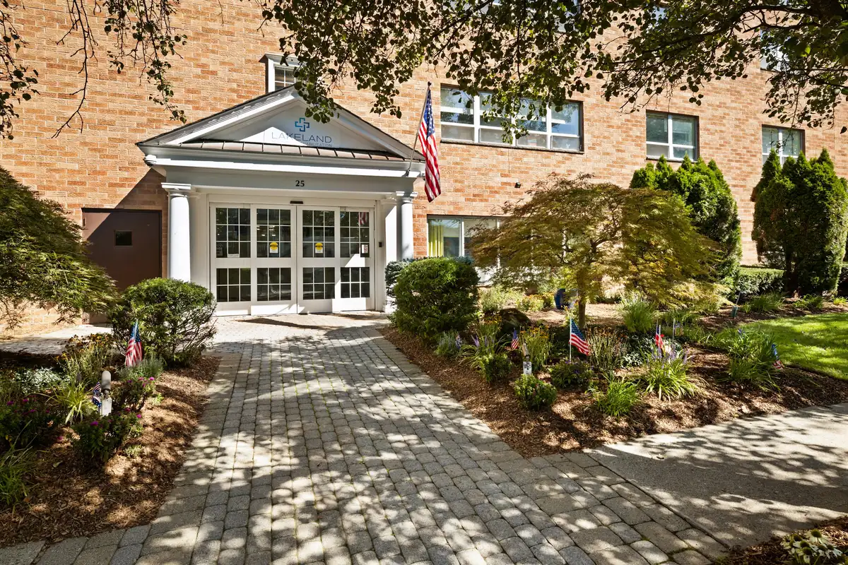 Front entrance of the Amara Rehab and Nursing building with brick facade and white portico