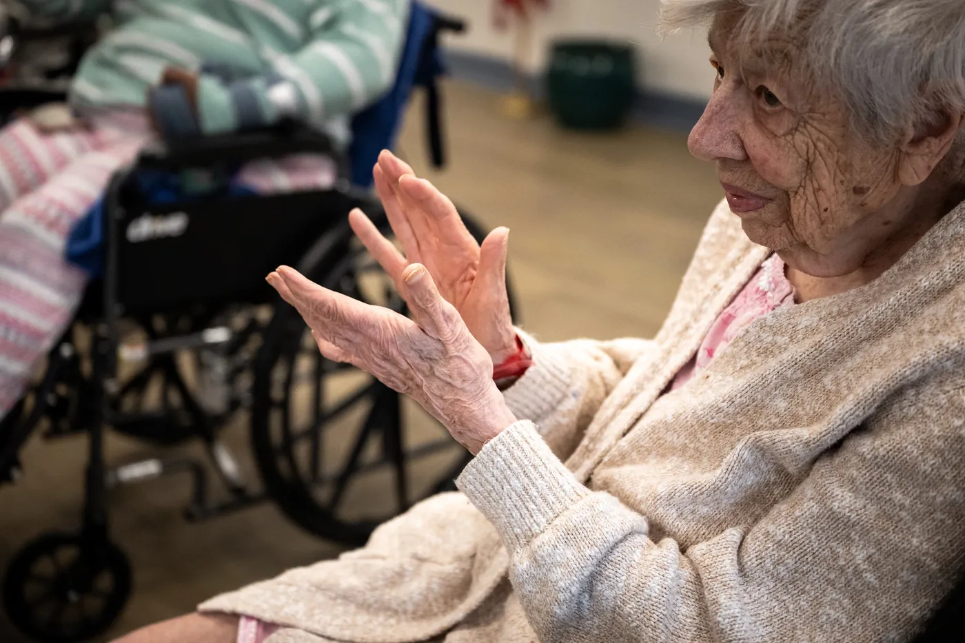 Resident smiling and clapping during a celebration