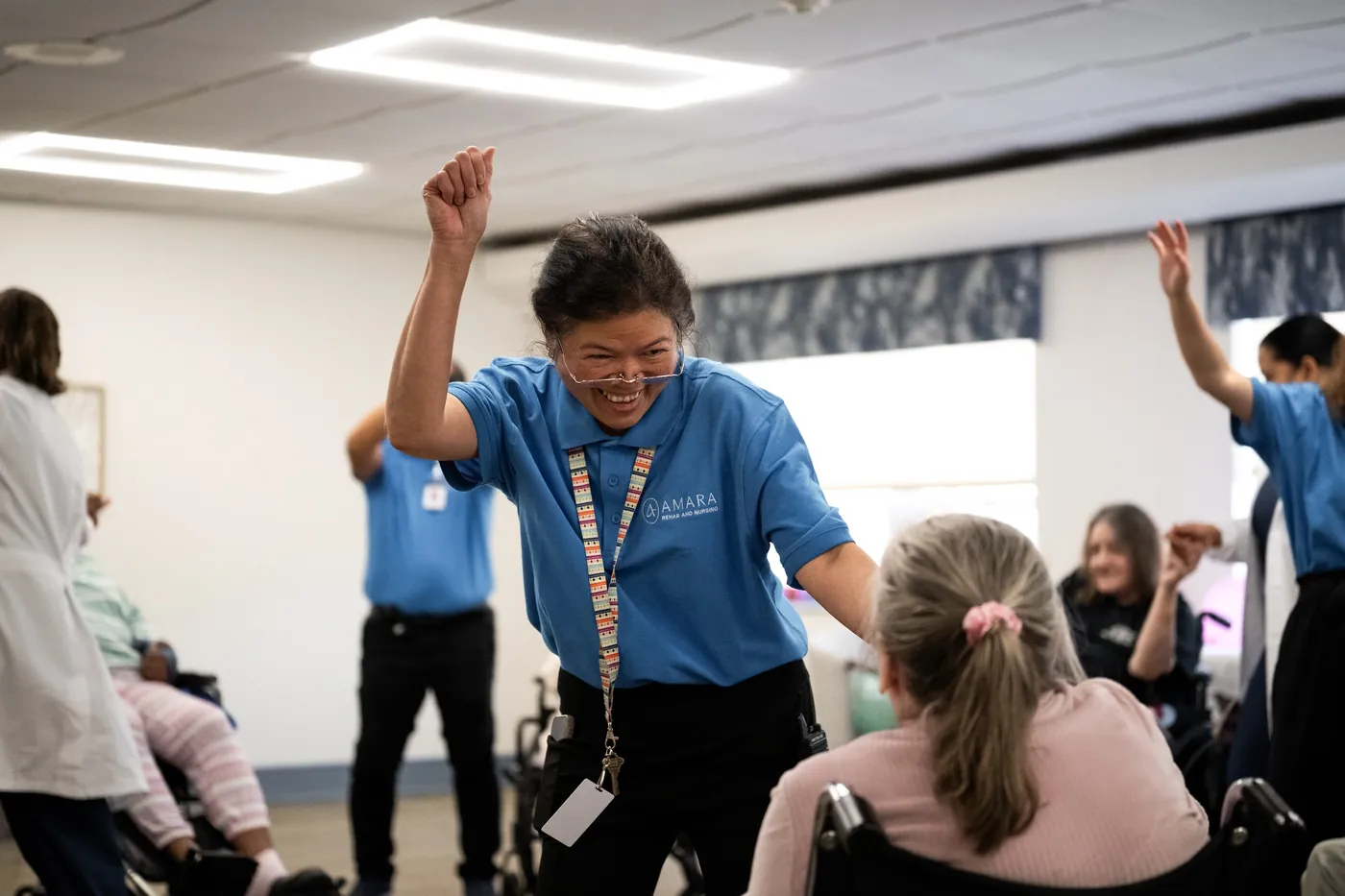 Amara team member cheering during a resident activity in the dayroom