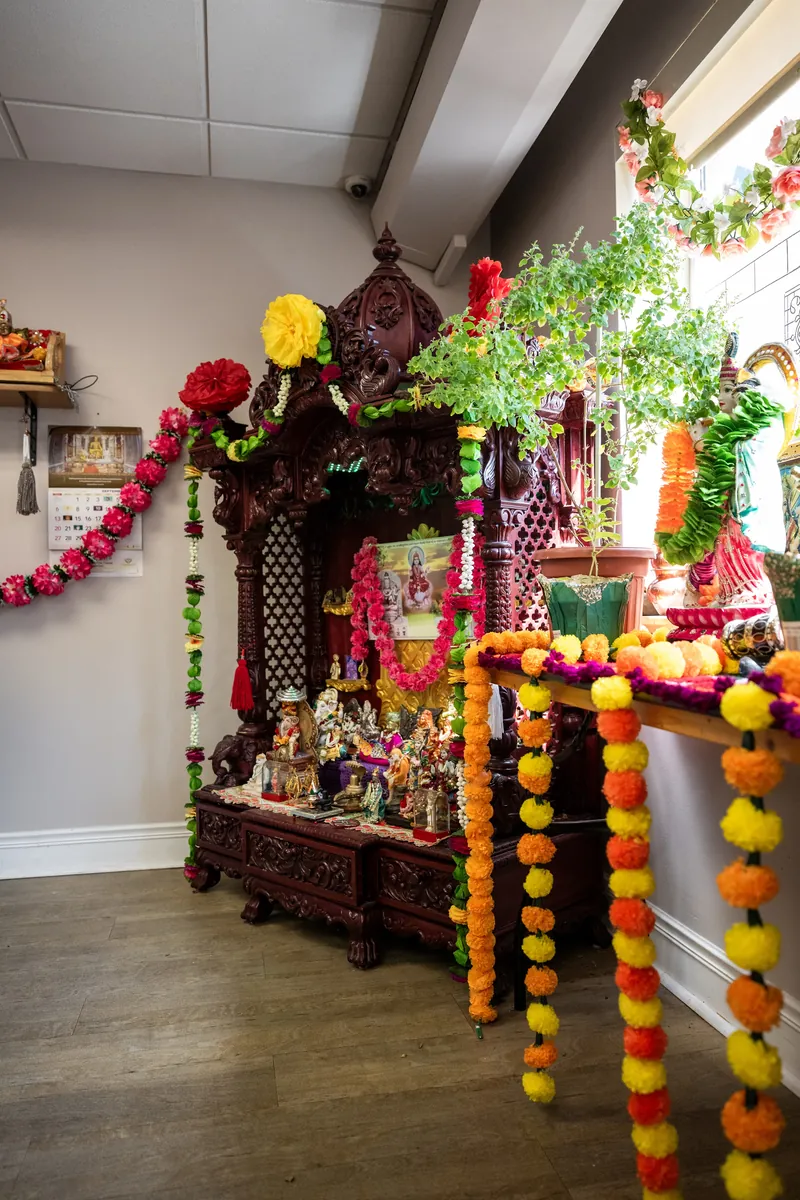 Wooden mandir decorated with marigold garlands for a festival