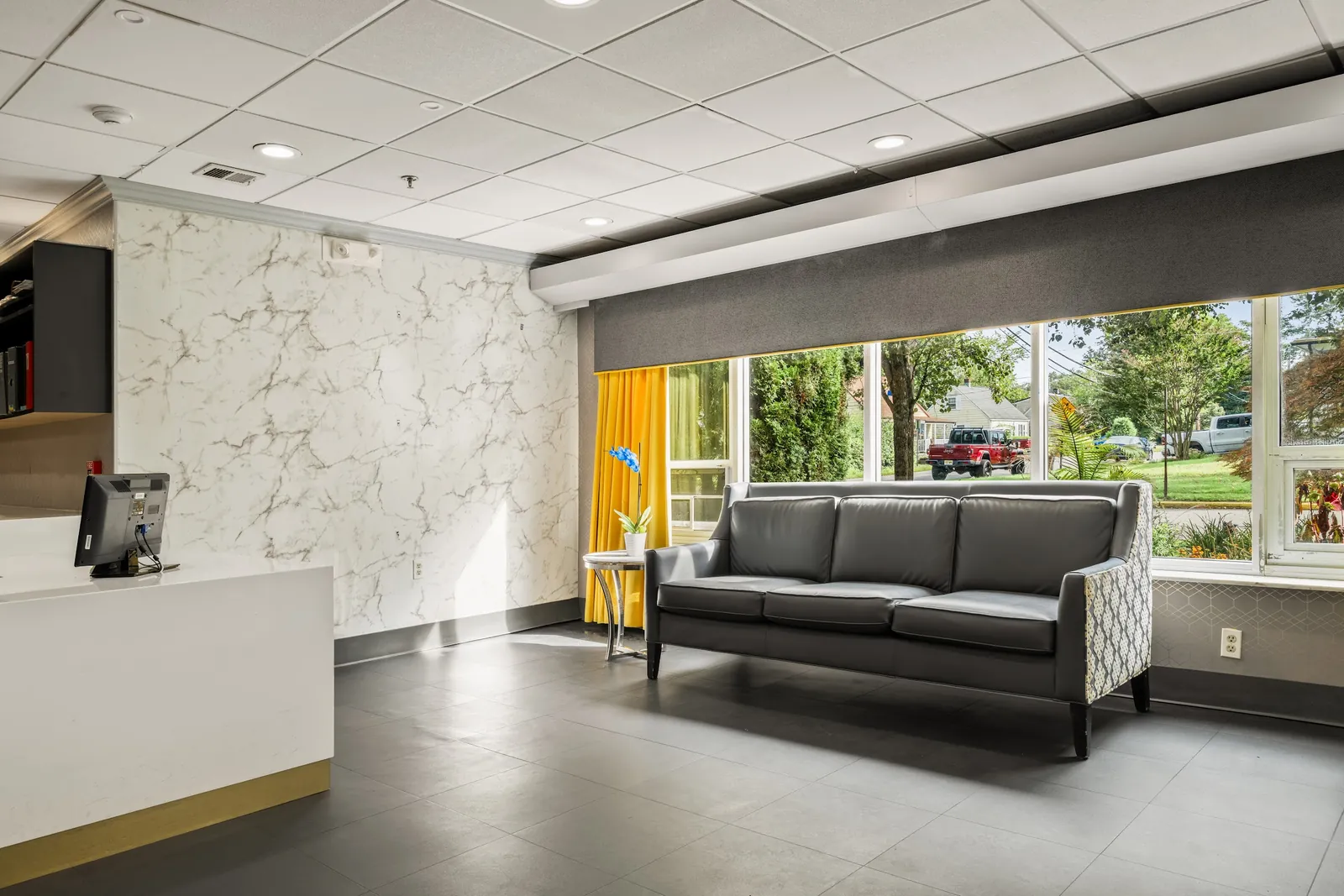 Lounge seating beside a bright window in the front lobby